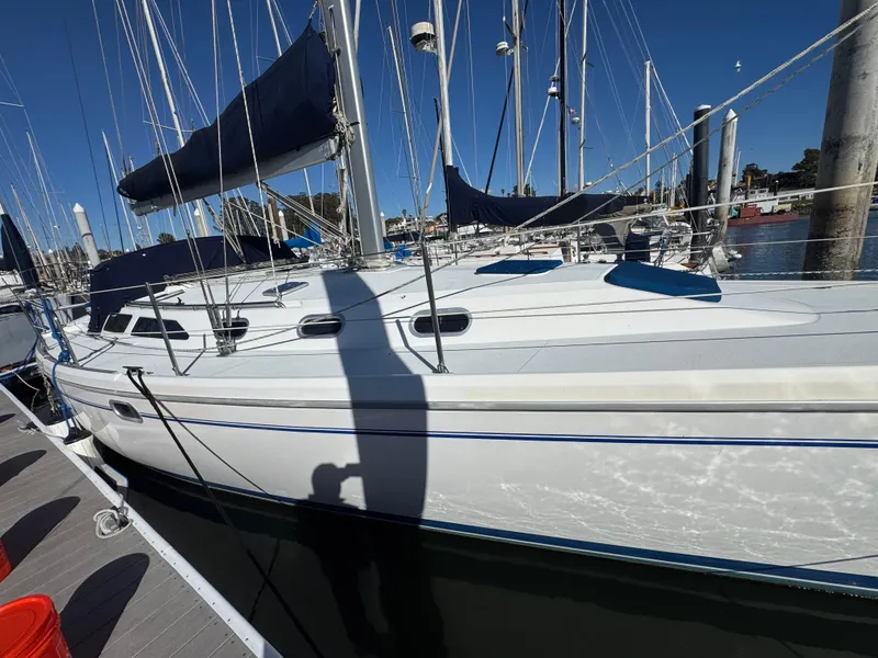 Slide: The Image of 2001 Catalina 42 MK II sailboat docked at marina, blue sails, sunny day. - 4
