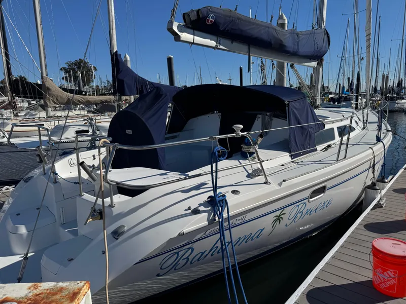Slide: The Image of 2001 Catalina 42 MK II sailboat docked in marina, featuring blue canvas covers. - 5