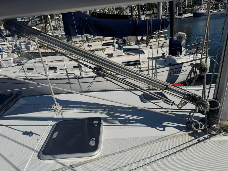 Slide: The Image of 2001 Catalina 42 MK II sailboat deck with rigging and marina background. - 9