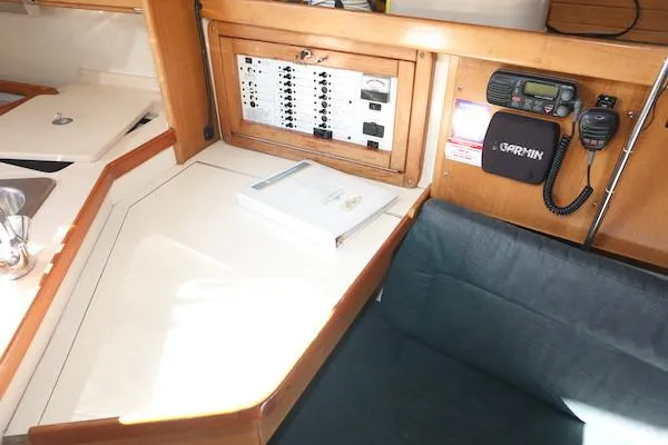 Slide: The Image of Navigation station in a 2000 Catalina 320 sailboat with control panel and communication equipment. - 11