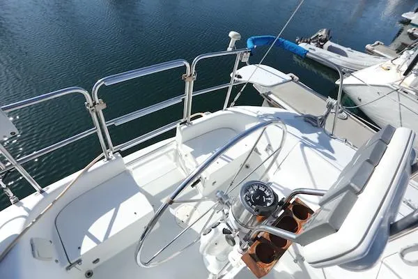 Slide: The Image of Cockpit of a 2000 Catalina 320 sailboat with steering wheel and compass. - 13