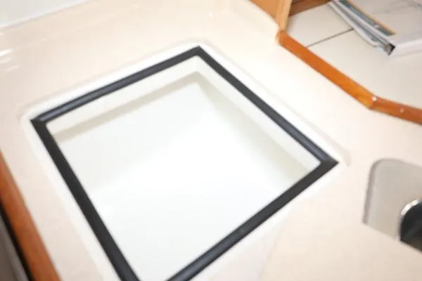 Slide: The Image of Interior detail of a 2000 Catalina 320 sailboat, featuring a built-in storage compartment. - 9