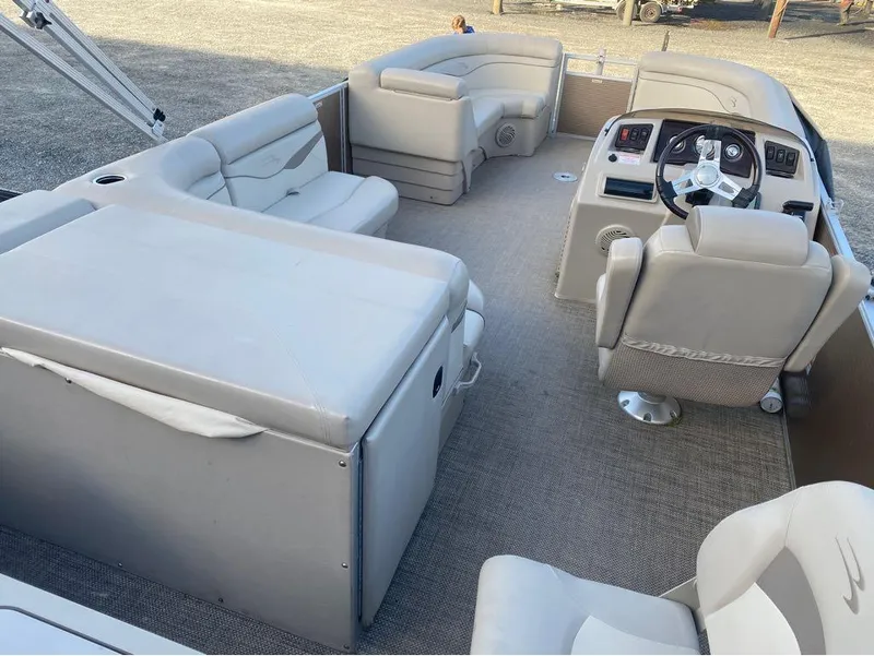 Slide: The Image of 2016 Bennington 22 SSX Elliptical Toon Package interior with plush seating and steering console. - 10