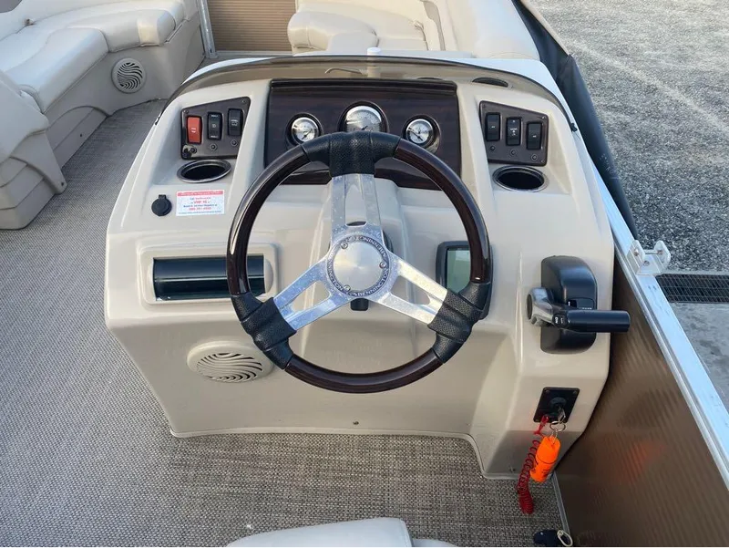 Slide: The Image of 2016 Bennington 22 SSX Elliptical Toon Package steering console with controls and gauges. - 12