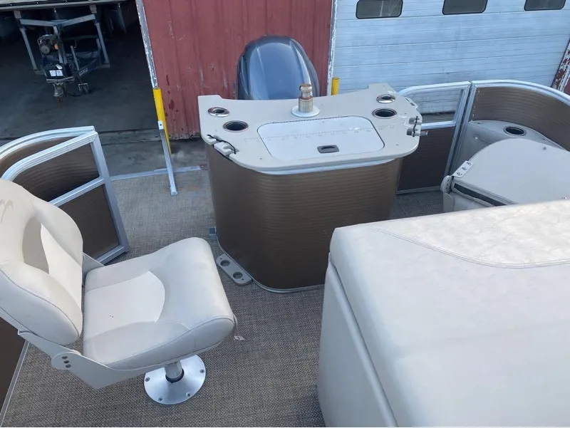 Slide: The Image of 2016 Bennington 22 SSX Elliptical Toon Package interior with seating and control console. - 13