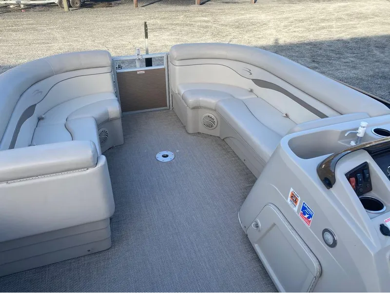 Slide: The Image of 2016 Bennington 22 SSX Elliptical Toon Package interior with spacious seating and control panel. - 5