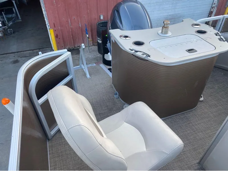 Slide: The Image of 2016 Bennington 22 SSX Elliptical Toon Package interior with seating and control console. - 9