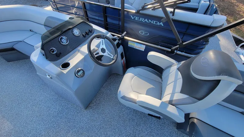 Slide: The Image of 2023 Veranda Vista 20 RC boat interior with steering console and seating. - 8