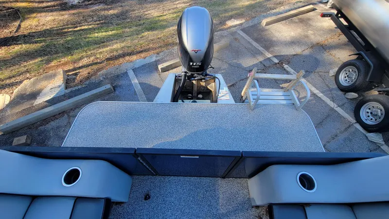 Slide: The Image of 2023 Veranda Vista 20 RC pontoon boat with outboard motor in parking lot. - 9