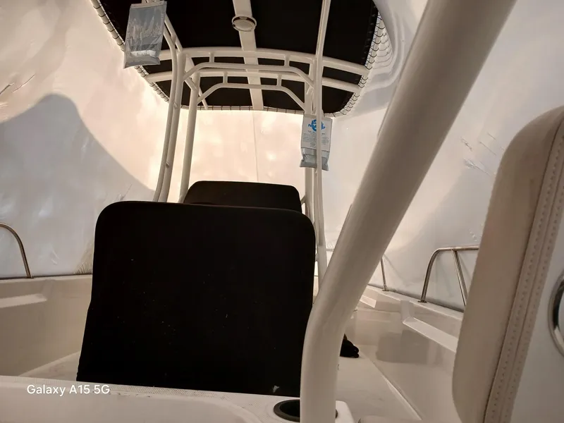 Slide: The Image of 2018 Boston Whaler 190 Montauk interior with black seating and canopy. - 18