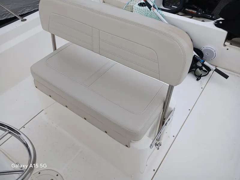 Slide: The Image of 2018 Boston Whaler 190 Montauk boat interior with beige seating and fishing gear. - 14