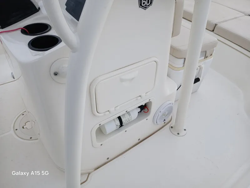 Slide: The Image of 2018 Boston Whaler 190 Montauk boat interior with storage compartment and cup holders. - 15