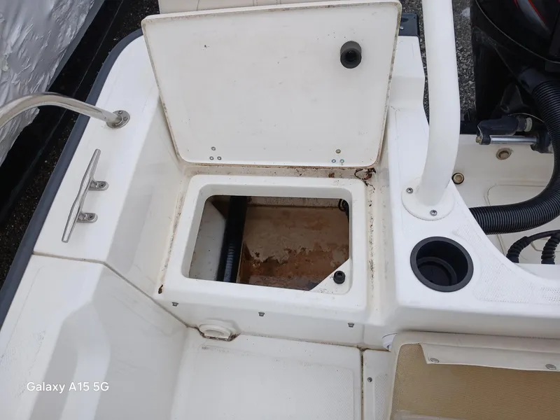 Slide: The Image of Open storage compartment on a 2018 Boston Whaler 190 Montauk boat deck. - 19