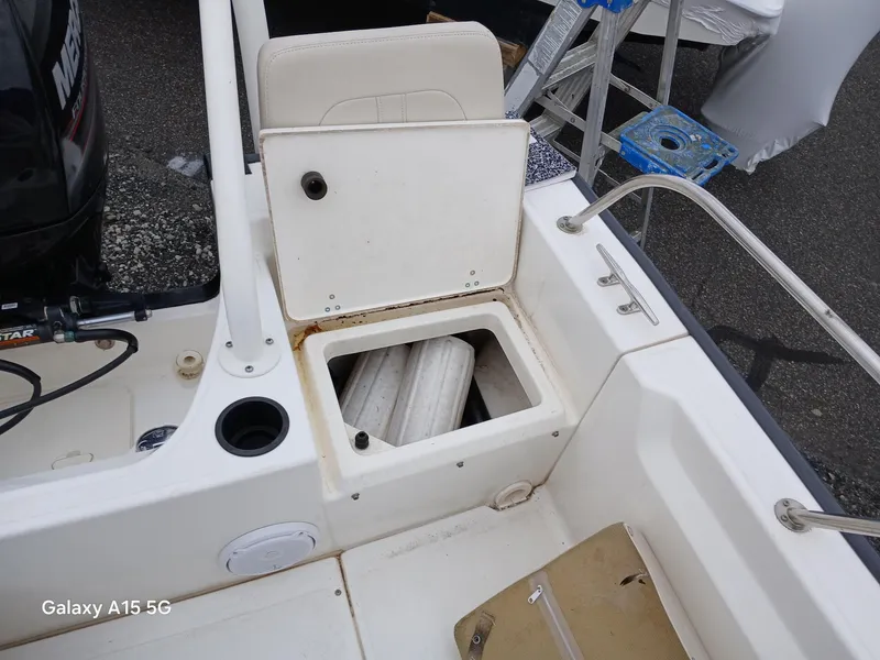 Slide: The Image of 2018 Boston Whaler 190 Montauk boat interior with open storage compartment. - 22