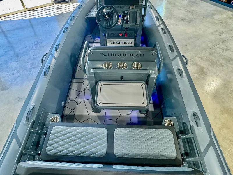 Slide: The Image of 2025 Highfield Sport 560 boat interior with modern seating and steering console. - 12