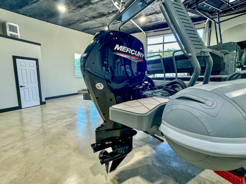 Slide: The Image of 2025 Highfield Sport 560 with Mercury outboard motor in showroom. - 18