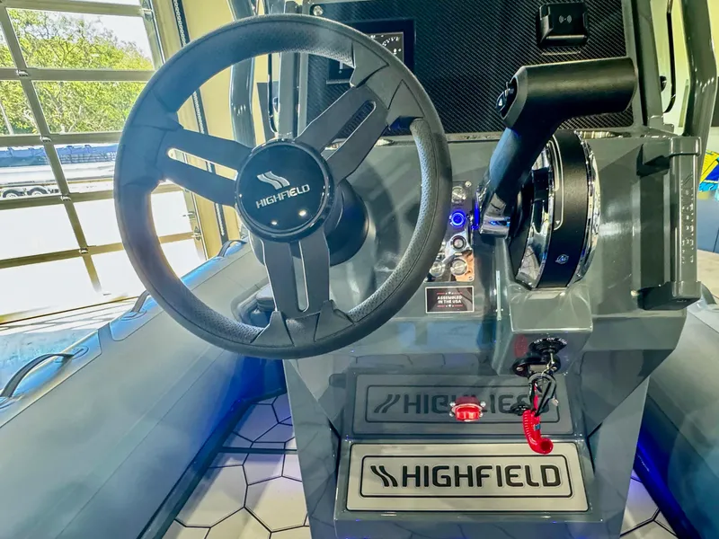 Slide: The Image of 2025 Highfield Sport 560 boat dashboard with steering wheel and controls. - 6