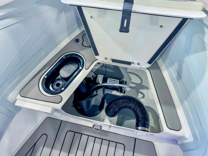 Slide: The Image of 2025 Highfield Sport 460 boat storage compartment with equipment and hose. - 11