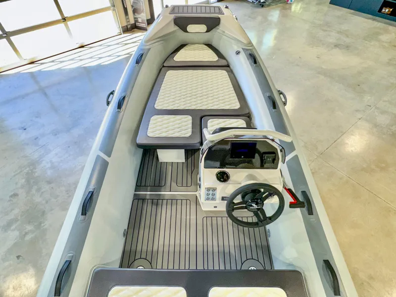 Slide: The Image of 2025 Highfield Sport 460 boat interior with modern steering console and cushioned seating. - 4