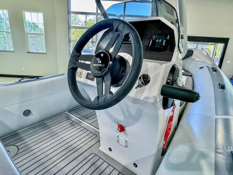 Slide: The Image of 2025 Highfield Sport 460 boat interior with steering wheel and control panel. - 6