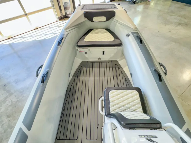 Slide: The Image of 2025 Highfield Sport 460 boat interior with cushioned seating and sleek design. - 7