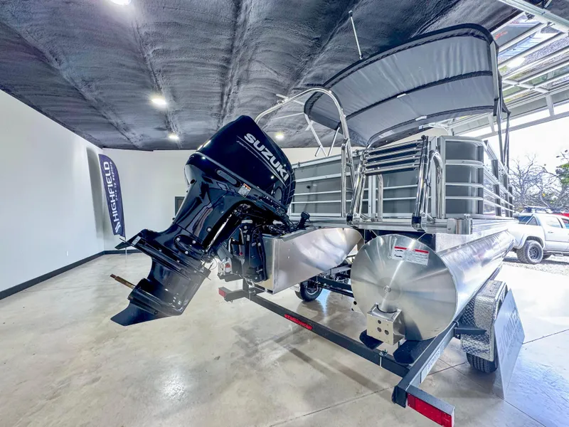 Slide: The Image of 2025 Berkshire 20′ LE pontoon boat with Suzuki outboard motor in showroom. - 4