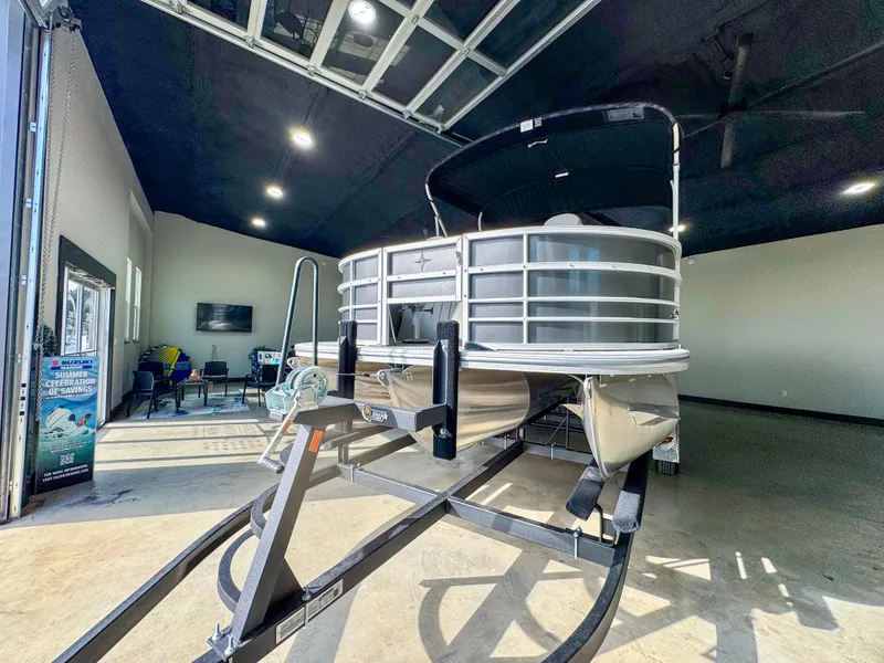Slide: The Image of 2025 Berkshire 20′ LE pontoon boat displayed indoors on a trailer. - 6