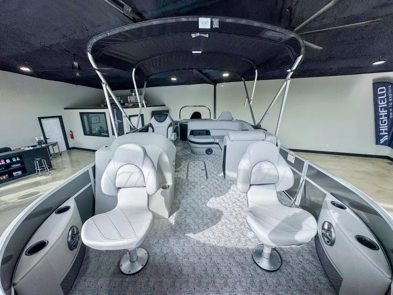 Slide: The Image of 2025 Berkshire 20′ LE pontoon boat interior with seating and canopy in showroom. - 7