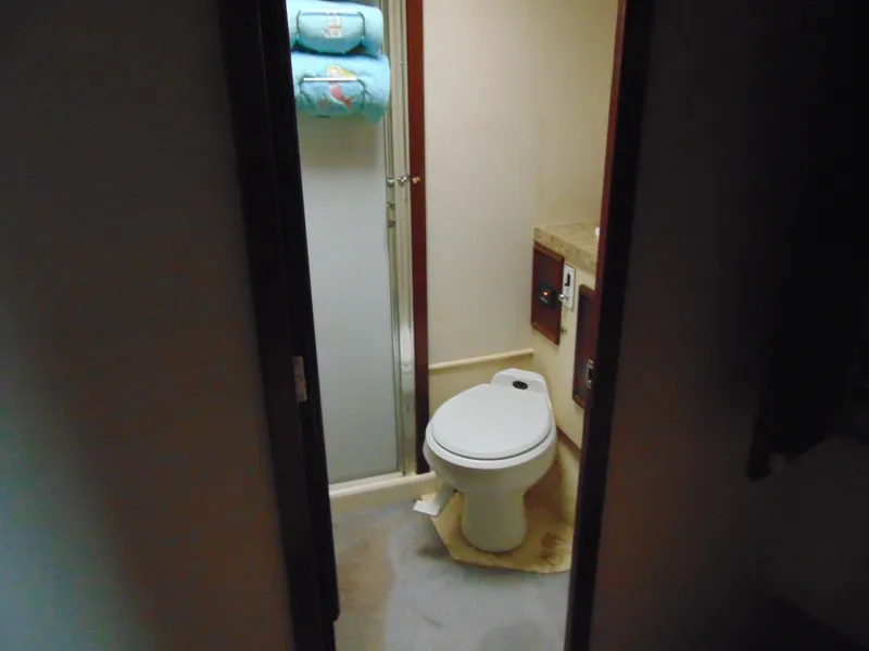 Slide: The Image of 1981 Post 46 Sportfish bathroom with toilet, shower, and towels. - 11