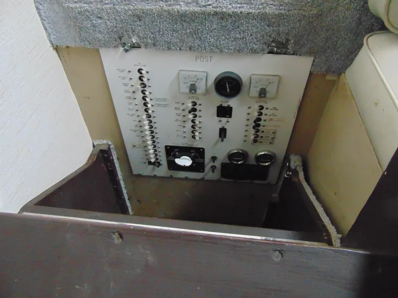 Slide: The Image of Electrical panel of a 1981 Post 46 Sportfish boat, featuring switches and gauges. - 12