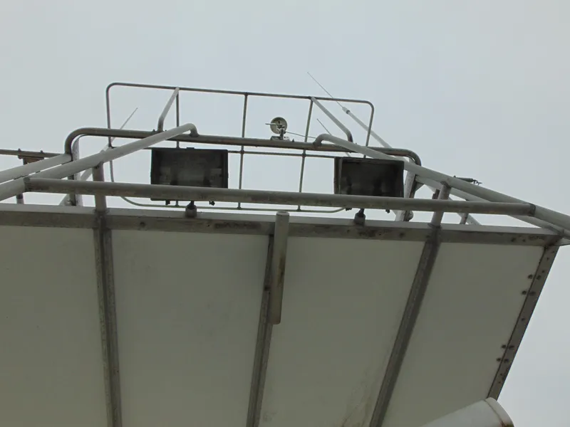 Slide: The Image of 1981 Post 46 Sportfish boat's upper deck with railing and equipment. - 17