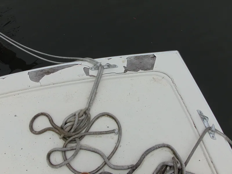 Slide: The Image of 1981 Post 46 Sportfish boat deck with worn paint and coiled rope. - 18