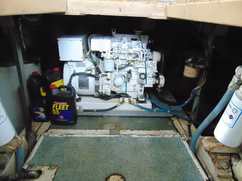 Slide: The Image of Engine room of 1981 Post 46 Sportfish with generator and oil containers. - 33