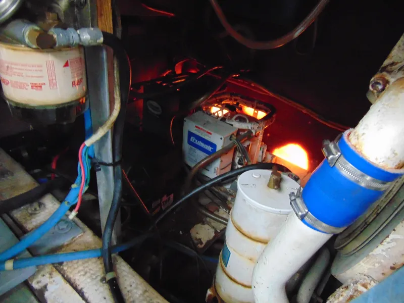 Slide: The Image of Engine room of 1981 Post 46 Sportfish boat with visible components and wiring. - 34