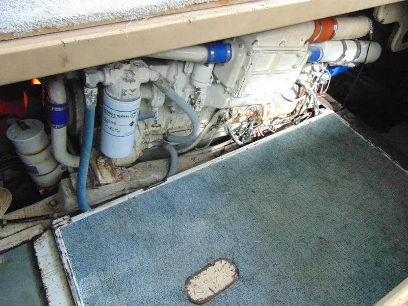 Slide: The Image of 1981 Post 46 Sportfish engine room with visible filters and piping. - 36