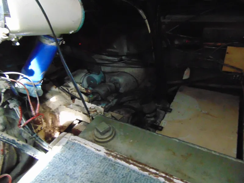 Slide: The Image of Engine room of 1981 Post 46 Sportfish boat, showing mechanical components and wiring. - 38