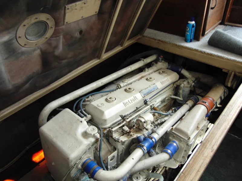 Slide: The Image of Engine compartment of a 1981 Post 46 Sportfish boat, showcasing mechanical components. - 42