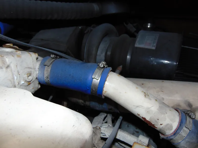 Slide: The Image of Engine components of a 1981 Post 46 Sportfish boat, featuring hoses and clamps. - 44