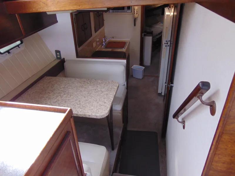 Slide: The Image of Interior of 1981 Post 46 Sportfish yacht with dining area and kitchenette. - 45