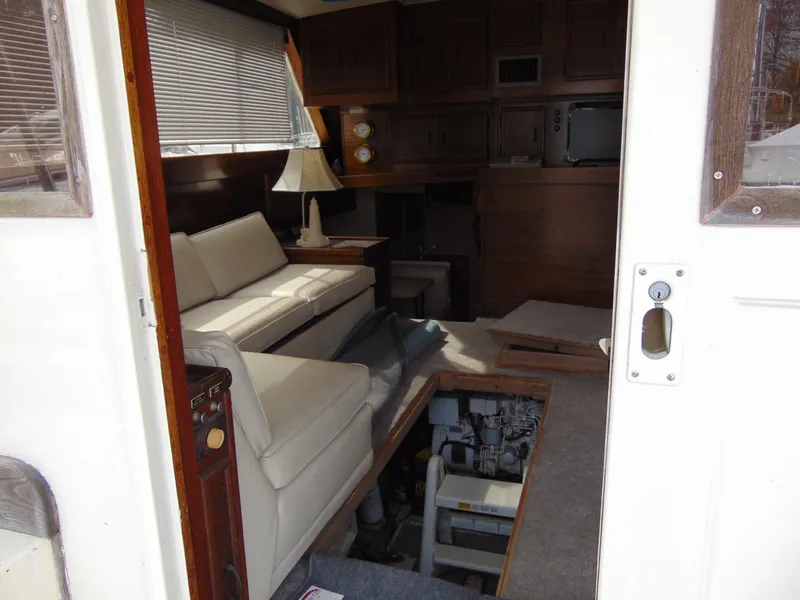 Slide: The Image of Interior of 1981 Post 46 Sportfish yacht with sofa, lamp, and engine access. - 46