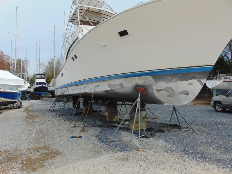 Slide: The Image of 1981 Post 46 Sportfish boat on stands, undergoing maintenance in a boatyard. - 25