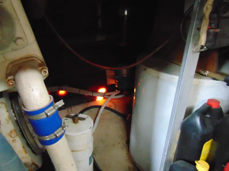 Slide: The Image of Engine room of 1981 Post 46 Sportfish boat with visible pipes and equipment. - 35