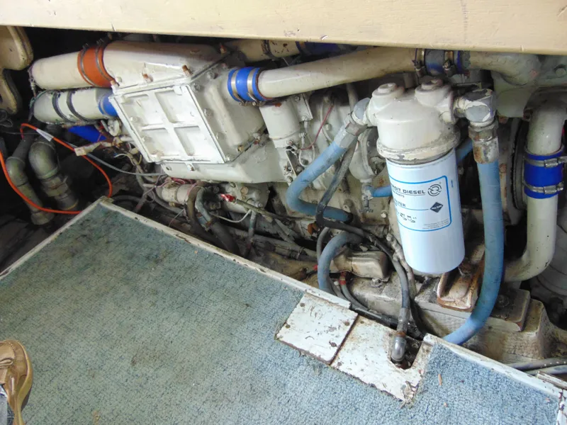 Slide: The Image of Engine room of 1981 Post 46 Sportfish boat, showcasing mechanical components and piping. - 37