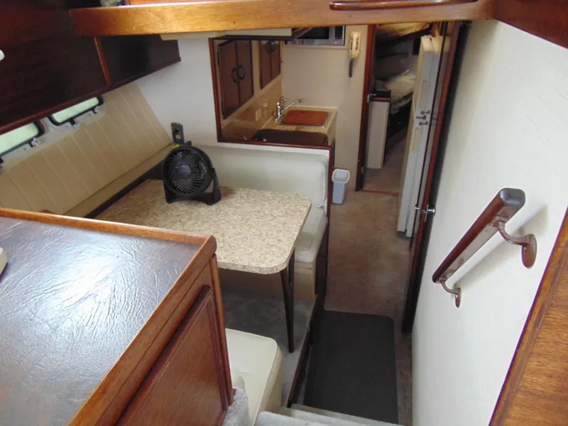 Slide: The Image of Interior of 1981 Post 46 Sportfish boat with dining area and kitchenette. - 5