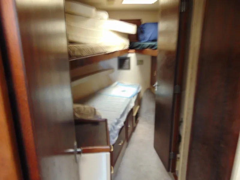 Slide: The Image of 1981 Post 46 Sportfish cabin with bunk beds and wooden interior. - 6