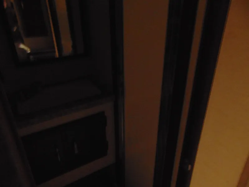 Slide: The Image of Dimly lit interior of 1981 Post 46 Sportfish boat, featuring a cabinet and mirror. - 8