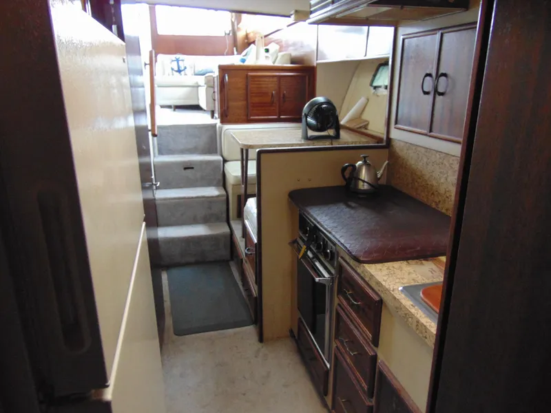 Slide: The Image of 1981 Post 46 Sportfish yacht interior with kitchen and seating area. - 9