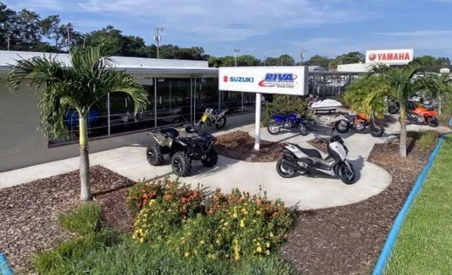Slide: The Image of Outdoor display of Yamaha WaveRunner EX 2024 and other vehicles at a dealership. - 12