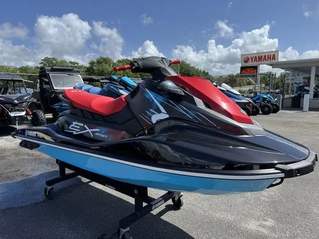 Slide: The Image of 2024 Yamaha WaveRunner EX in red and yellow, displayed outdoors on a stand. - 2