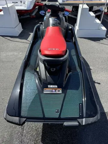 Slide: The Image of 2024 Yamaha WaveRunner EX in vibrant red, parked among other jet skis. - 7